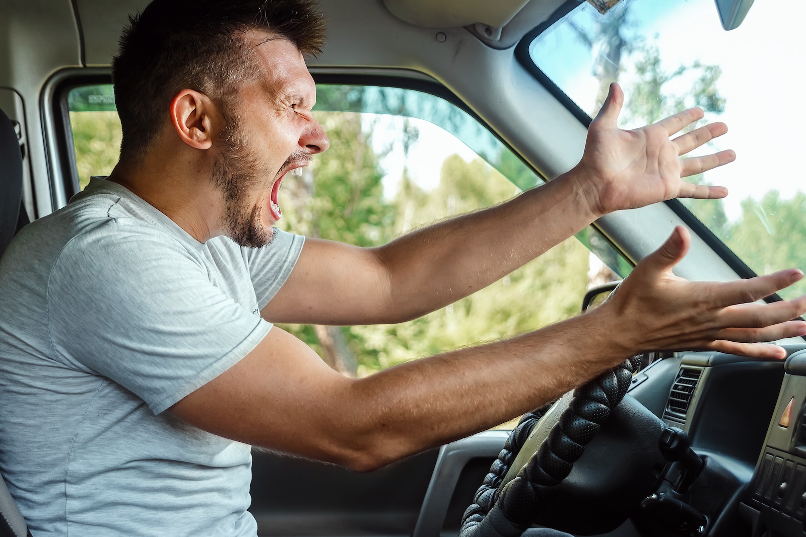man with hands up yelling