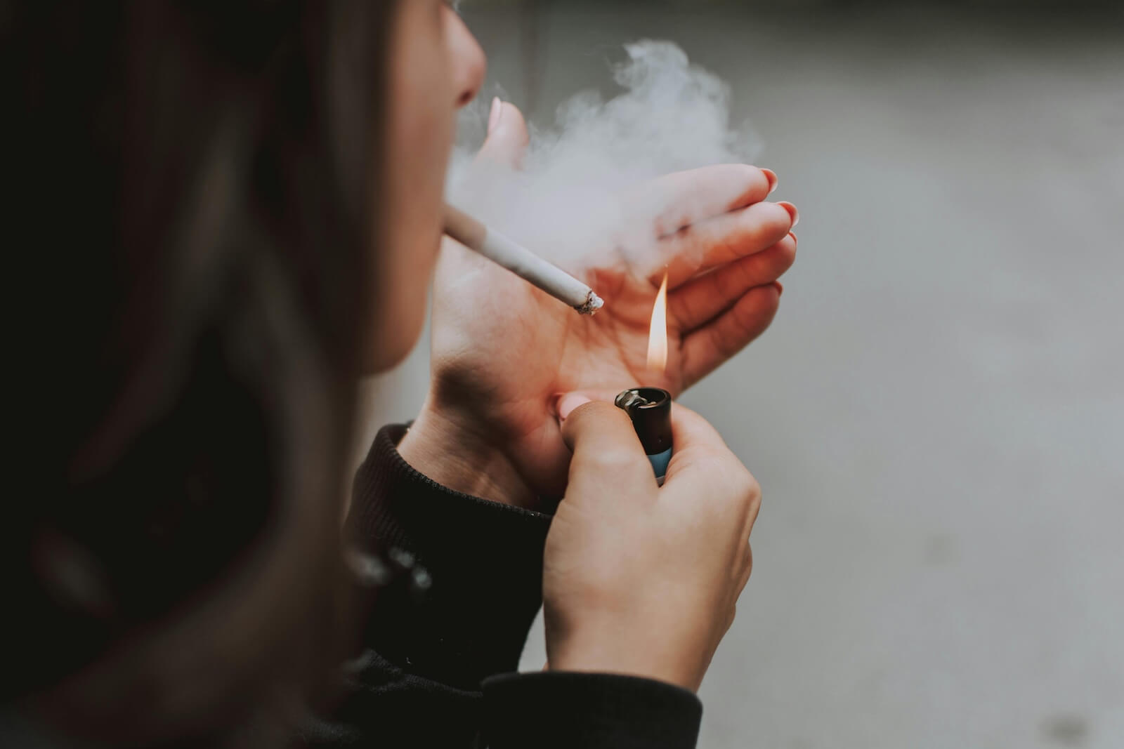 person lighting a cigarette 
