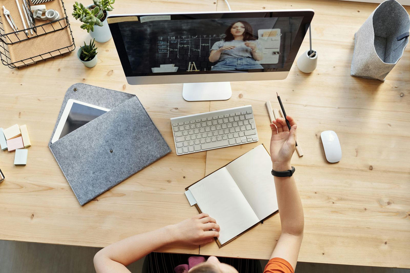 top down view of person at a laptop taking notes