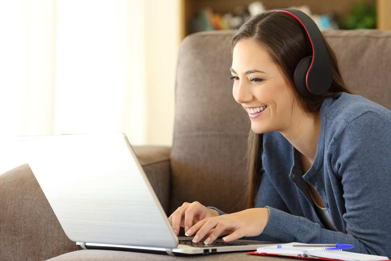 Woman smiling while using laptop