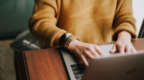 person typing on laptop isae